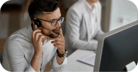 Man with a headset working at a computer